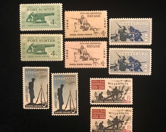 May include: A collection of nine vintage United States postage stamps commemorating the Civil War Centennial. The stamps feature various scenes from the war, including Fort Sumter, Shiloh, Gettysburg, Appomattox, and The Wilderness. The stamps are in mint condition and are a great addition to any stamp collection.