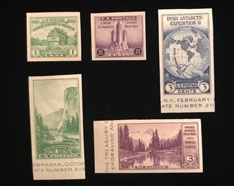 May include: A collection of vintage postage stamps featuring various designs, including a building, a globe, a mountain, and a forest scene. The stamps are green, blue, and purple and have the text "U.S. Postage" and the year "1933" printed on them.