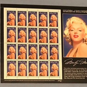 May include: A sheet of 20 US postage stamps featuring a portrait of Marilyn Monroe. The stamps are arranged in a 4x5 grid. The stamps are surrounded by a black border. The sheet also includes a larger image of Marilyn Monroe and a quote about her. The text on the sheet reads "Legends of Hollywood" and "Marilyn Monroe".