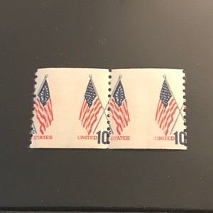 May include: A sheet of four 10-cent United States postage stamps featuring crossed American flags.