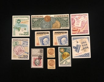 May include: A collection of vintage postage stamps featuring various designs and denominations. The stamps include themes like stamp collecting, banking, commerce, and numismatics. Some stamps have the text "USA" and "22" or "13" printed on them.