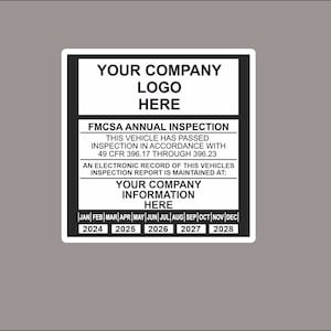 May include: Black and white sticker with the text "Your Company Logo Here" and "FMCSA Annual Inspection". The sticker also includes the text "This vehicle has passed inspection in accordance with 49 CFR 396.17 through 396.23". The sticker has a calendar with the months of the year and the years 2024 through 2028.