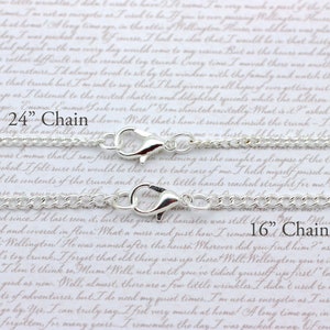 May include: Two silver chains with lobster clasps. The top chain is 24 inches long and the bottom chain is 16 inches long.