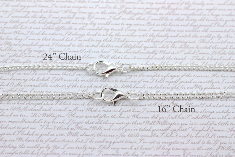 May include: Two silver chains with lobster clasps. The top chain is 24 inches long and the bottom chain is 16 inches long.