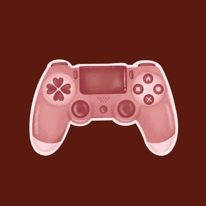 May include: A pink video game controller with a white outline, set against a dark red-brown background. The controller features heart-shaped buttons and standard gaming controls.