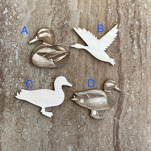 May include: Four wooden duck and goose cutouts. Two are detailed with a woodgrain pattern, and two are plain. The cutouts are labeled A, B, C, and D.
