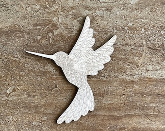 May include: White wooden hummingbird cutout with intricate details, perfect for crafting or home decor.