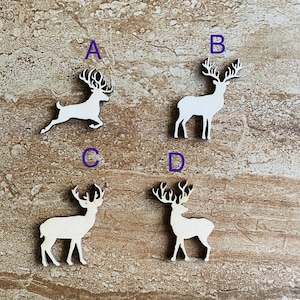 May include: Four white wooden reindeer cutouts with antlers. The reindeer are arranged in a square pattern on a brown wooden background.