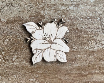 May include: A white wooden cutout of a flower with intricate details. The flower has five petals and is surrounded by leaves.