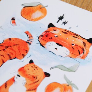 May include: A watercolour illustration of a tiger with orange and black stripes. The tiger is swimming in water with bubbles around it. There are also orange fruits with green leaves in the image.