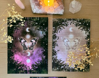 May include: Set of three stationery cards featuring a purple and pink butterfly with moon phases and a starry night sky background. The cards are printed on white paper with lined writing space.