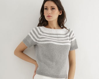 May include: A gray short-sleeved knitted top with white horizontal stripes across the chest.