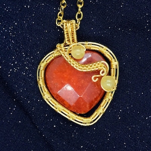 Gold wire wrapped deep orange stone heart