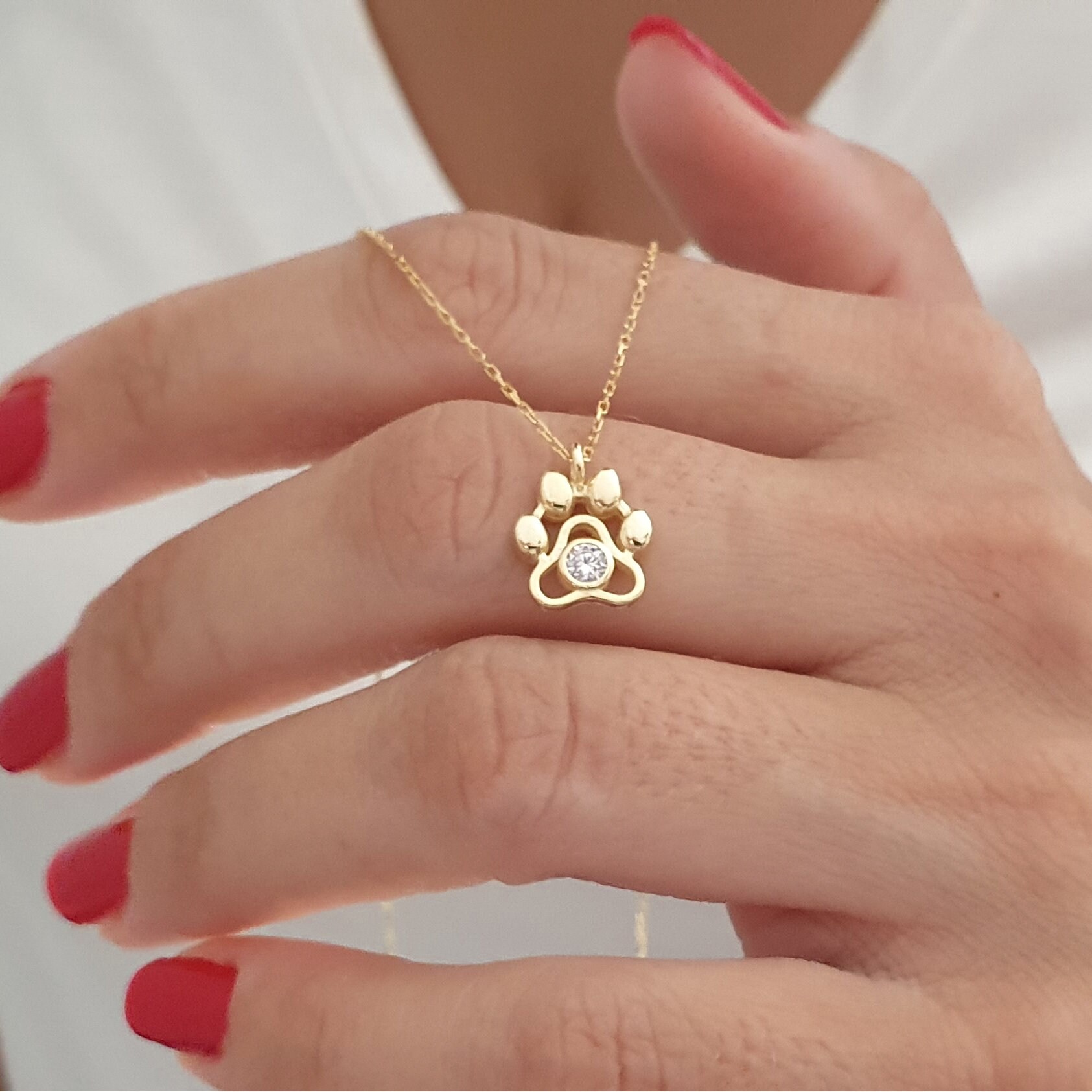 Gold dog paw pendant deals