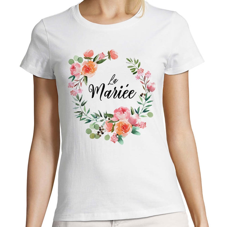 May include: White t-shirt with a floral wreath design and the text "La Mari&eacute;e" in black.