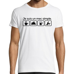 May include: White t-shirt with black text that reads "Je suis un mec simple."  The text is surrounded by four icons: a cup of coffee, a motorcycle, a beer mug, and a couple.