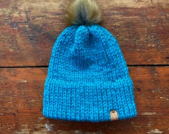 Bright blue double brim knit hat made with 100% Peruvian Highland Wool and Faux Fur Pom-Pom.