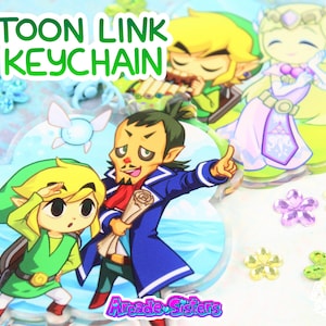 May include: A selection of acrylic keychains featuring characters from the Toon Link series. The keychains display various characters in bright colours, with the text "TOON LINK KEYCHAIN" in green. Decorative floral accents surround the keychains.
