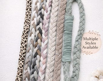 May include: A collection of soft fabric headbands featuring braided and stretch styles in various colors and patterns, including leopard print, grey, pink, and sage green. The text reads Soft Fabric Headbands, Braided & Stretch Styles, Multiple Styles Available, Comfortable, Stretchy, Everyday.