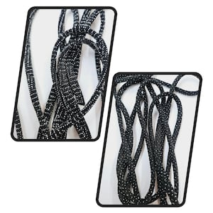 May include: Black shoelaces with silver glitter. The shoelaces are coiled and arranged in a decorative pattern.