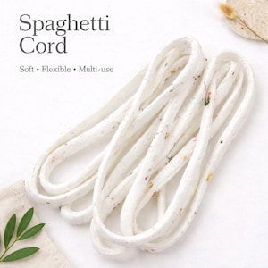 May include: A set of three ceramic mugs with a speckled, matte finish. The mugs are in shades of cream, light gray, and dark gray. Each mug has a simple, minimalist design, perfect for coffee or tea.