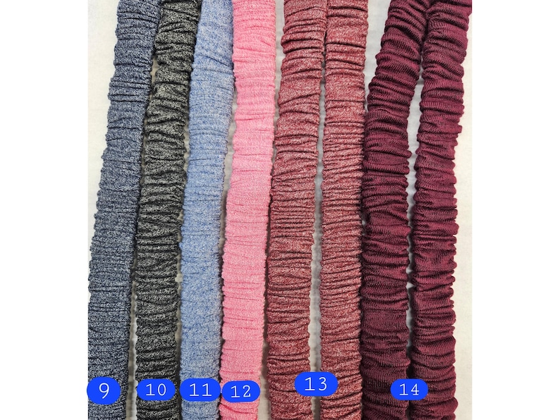 Puede incluir: Una selecci&oacute;n de bandas el&aacute;sticas en varios colores, incluyendo azul marino, carb&oacute;n, azul claro, rosa y burdeos. Cada banda est&aacute; fruncida, creando una apariencia texturizada. Los n&uacute;meros 9 a 14 son visibles en las bandas.
