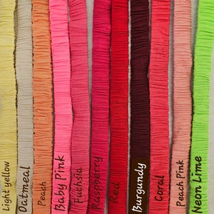 May include: Eleven vertical fabric strips in various colors, each featuring a gathered, textured surface. The colors are labeled as light yellow, oatmeal, peach, baby pink, fuchsia, raspberry, red, burgundy, coral, peach pink, and neon lime.
