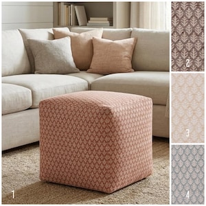 May include: A square fabric ottoman featuring a repeating leaf pattern in terracotta and white. The ottoman is displayed alongside three additional fabric swatches labeled 2, 3, and 4, showing the same leaf design in brown, beige, and blue colorways.