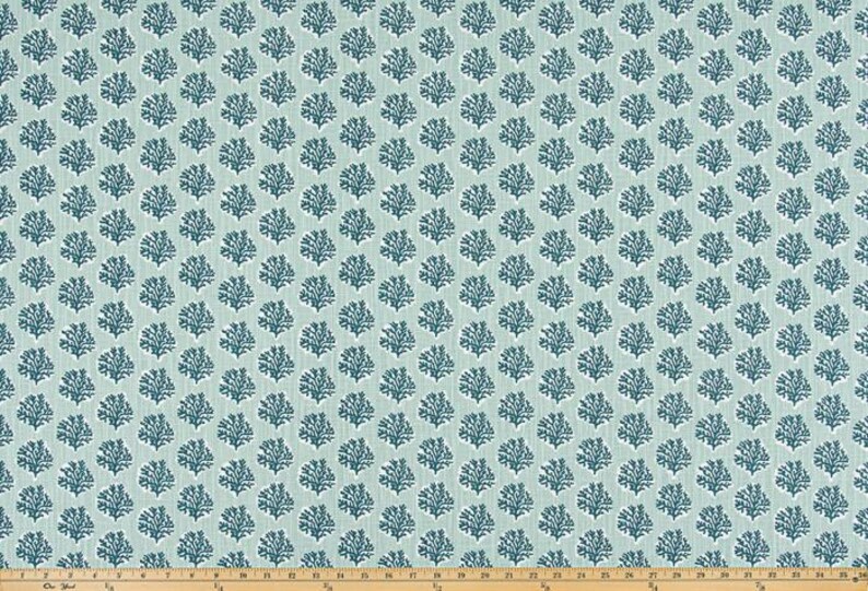 May include: A fabric with a repeating pattern of stylized coral branches in a dark teal color against a light teal background. The coral pattern is evenly spaced across the fabric, creating a textured appearance. The fabric is likely used for upholstery or home decor.