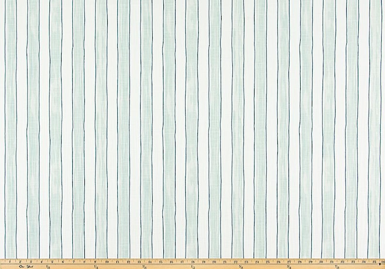 May include: Fabric with a vertical stripe pattern. The design features alternating stripes of white, light blue-green, and dark blue-green. The stripes are evenly spaced and run the length of the fabric. The fabric is likely used for home decor or apparel.