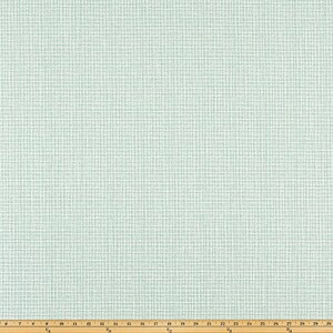 May include: A close-up of a light blue fabric with a grid pattern. The fabric has a textured appearance and is laid out on a wooden measuring board. The grid pattern is made up of thin white lines.