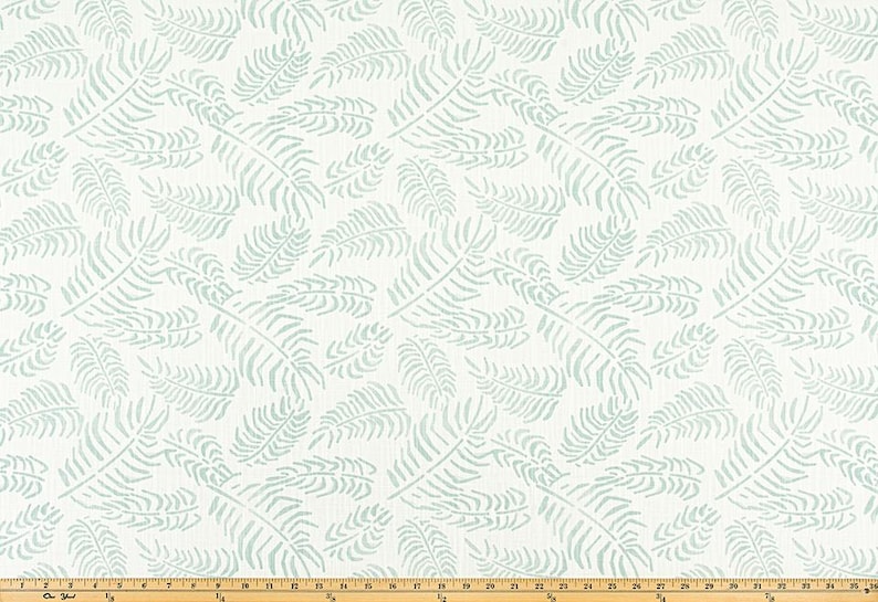 May include: White fabric with a repeating pattern of light blue fern leaves. The leaves are stylized and scattered across the surface. The fabric is suitable for various home decor projects.