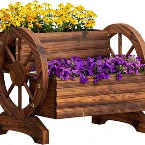 May include: A rustic wooden planter shaped like a wagon, filled with vibrant yellow and purple flowers. The planter features two wooden wheels and is constructed from stained wood, creating a charming outdoor decor piece.