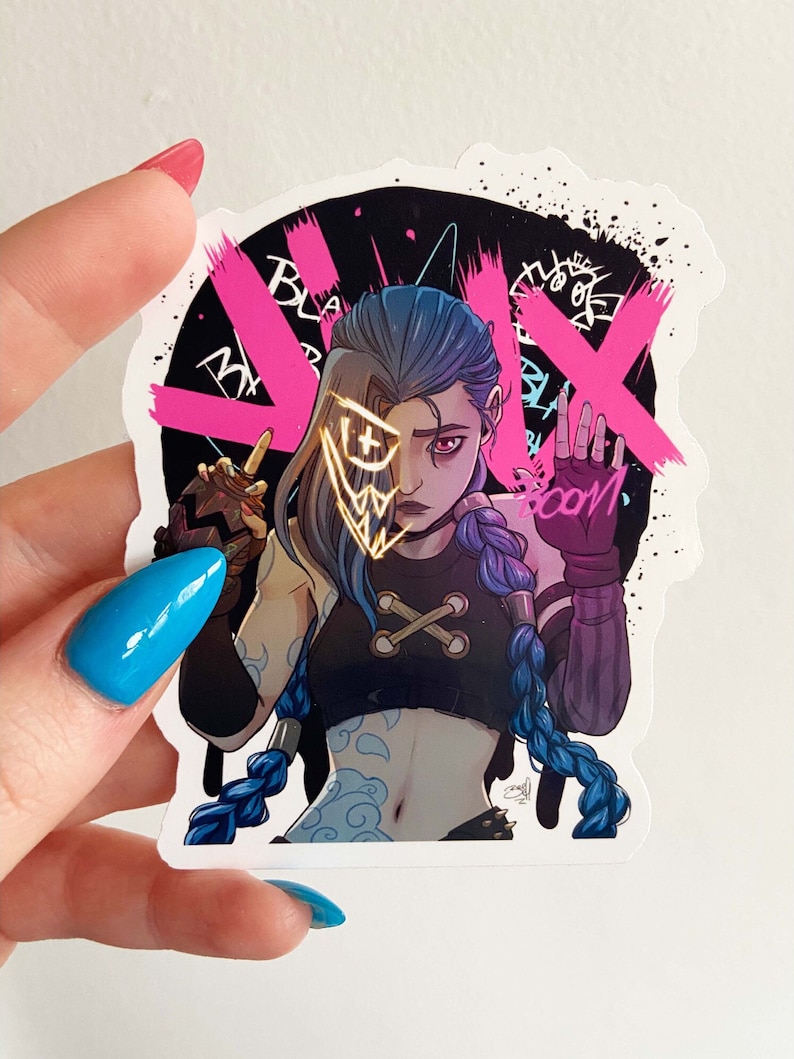 May include: A sticker featuring a cartoon illustration of a female character with blue hair and a gold mask. The character is wearing a black tank top with a white cross on it and a black and white bandana. The background is black with pink and white graffiti. The text "BOOM" is written in white on the sticker.