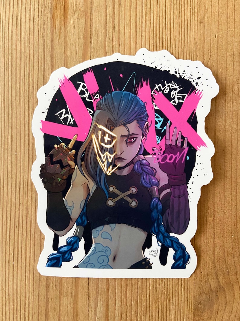 May include: A sticker featuring a cartoon illustration of a female character with blue hair and a black and white outfit. The character is wearing a mask with a gold and yellow design. The background is black with pink graffiti and the word "BOOM" in pink.