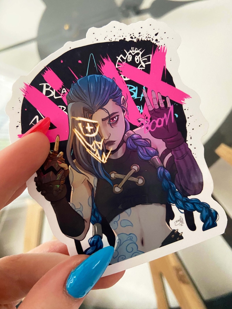 May include: A sticker featuring a cartoon character with blue hair and a black and white outfit. The character has a gold mask over their face and is holding a weapon. The sticker has a pink and black background with the words "Black Boom" written on it.