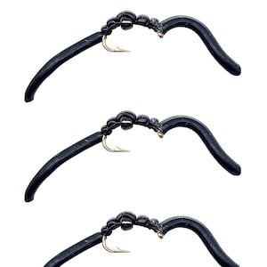 May include: Three black rubber fly fishing lures with gold hooks and a black bead on each lure.