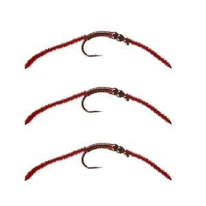 May include: Three red and brown fly fishing lures with a hook and a bead on each.
