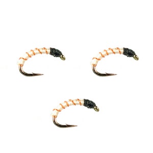May include: Three white and orange fly fishing lures with black heads.