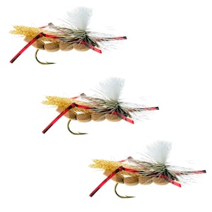 May include: Three fly fishing lures with brown, red, and gold accents. The lures have white, fluffy tails and are tied with brown and red thread.