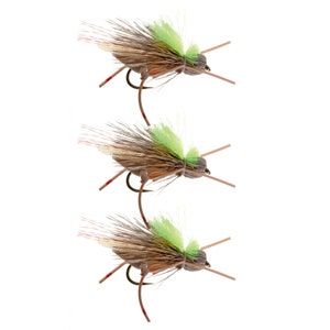 May include: Three brown and green fly fishing lures with brown and white feathers and a green body.