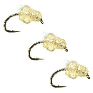 May include: Three gold fishing flies with clear, translucent, beaded bodies.
