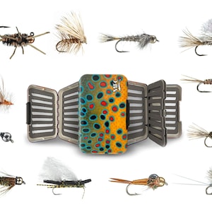 May include: An assortment of artificial fishing flies surrounds an open fly box. The fly box has a brown, orange, and blue design. The flies are in various colors and styles, designed to mimic insects.
