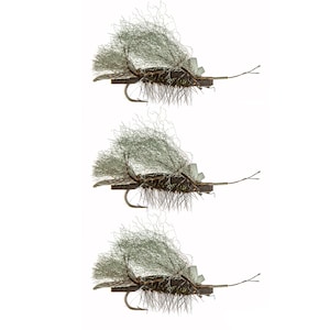 May include: Three fly fishing lures with brown bodies, gray wings, and brown legs. The lures are tied on hooks.