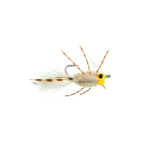 May include: A tan and brown fly fishing lure with white feathers and yellow eyes.