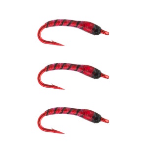 May include: Three red and black fly fishing lures with a hook on each.