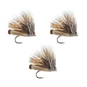 May include: Three brown and gray fly fishing lures with brown and white feathers.