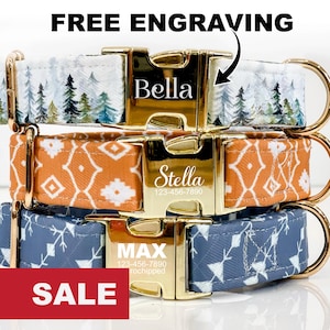 May include: Three dog collars with gold buckles and personalised engravings. The collars are in different patterns: white with green trees, orange with a geometric pattern, and blue with a white geometric pattern. The engravings read "Bella", "Stella 123-456-7890", and "MAX 123-456-7890 microchipped".