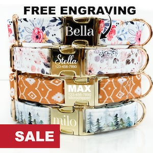 May include: Four dog collars with different patterns and personalized engraved gold name tags. The collars are stacked on top of each other. The top collar has a floral pattern and says "Bella". The second collar has a floral pattern and says "Stella 123-456-7890". The third collar has a geometric pattern and says "MAX 123-456-7890 Microchipped". The bottom collar has a forest pattern and says "milo".