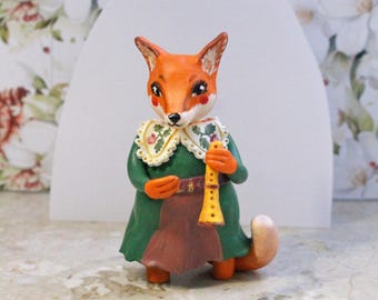 Fox figurine with flute, hand painted clay fox in green dress, cottagecore woodland animal decor, gift for musician
